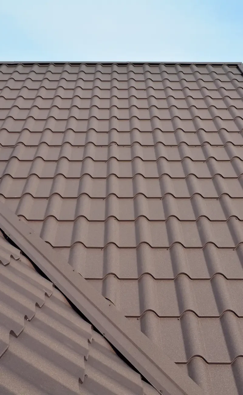 Metal roof construction with coaxial chimney pipe heating system against blue sky. Metal roof construction with coaxial chimney pipe heating system against blue sky.